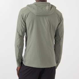 Model wearing Arcteryx Atom SL Hoodie Jacket in Forage, rear view showing StormHood and lightweight fit, styled with dark trousers.