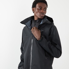 Model wearing black hooded waterproof jacket with zip fastening, adjustable collar detail, cropped torso view