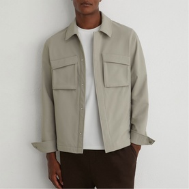 Model wearing Reiss beige overshirt with chest patch pockets, styled with a white tee and dark brown trousers