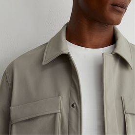 Model wearing Reiss beige overshirt with chest patch pockets, layered over a white crew-neck T-shirt.