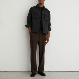Model wearing Reiss black overshirt with chest pockets, styled with dark brown tailored trousers and black loafers