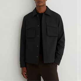 Model wearing Reiss black overshirt jacket with chest patch pockets and snap button fastening, styled with dark trousers