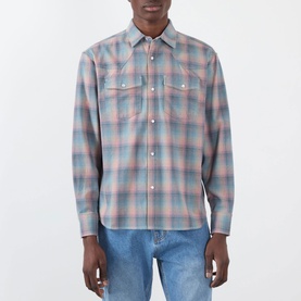 Model wearing Pleasures pink cotton plaid casual shirt with snap buttons, chest pockets, styled with light blue jeans.