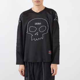 Model wearing Pleasures Jamie Hockey Jersey in black with skull graphic, V-neck, long sleeves, and mesh design, styled with black shorts
