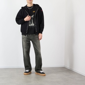 Model wearing Pleasures Ritual Graphic Print Logo T-Shirt in black, styled with black zip hoodie, dark jeans, and black trainers.
