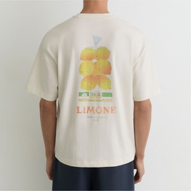 Model wearing Reiss white oversized T-shirt, back view showing yellow floral Limone graphic print.