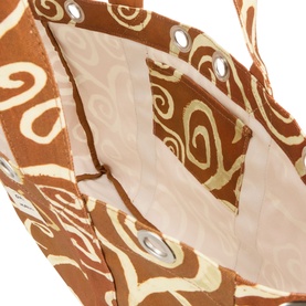 Damson Madder brown cotton tote bag, interior view showing cream lining, swirl print fabric, and silver eyelet detailing along top edge.