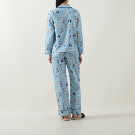 Model wearing Polo nightwear set in All Over Bear print, light blue cotton pyjamas with contrast piping, back view shown.
