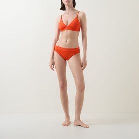 Model wearing Lauren Bikini Brief in Sunburst Orange, styled with matching triangle bikini top