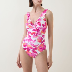 Model wearing Lauren swimsuit in multi floral pink print, featuring V-neckline with twist detail and ruched sides