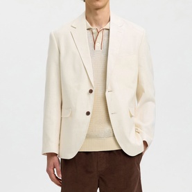 Model wearing Selected egret blazer with two-button fastening, styled with a knit sweater and brown corduroy trousers