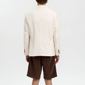 Model wearing Selected egret blazer, rear view, styled with brown shorts
