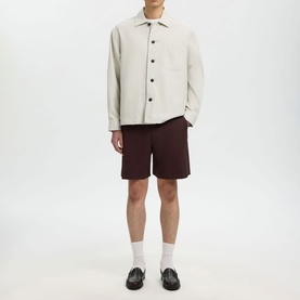 Model wearing Selected White Pepper casual shirt with dark burgundy shorts, white socks and black loafers