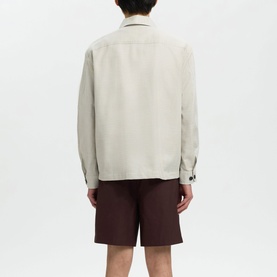 Model wearing Selected Casual Shirt in White Pepper, shown from behind, styled with dark burgundy shorts