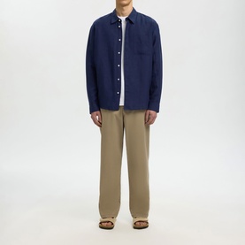 Model wearing Selected Casual Shirt in Ocean Cavern navy, styled with khaki wide-leg trousers and brown sandals