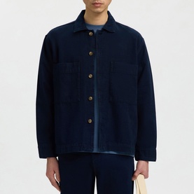 Model wearing Selected dark blue denim casual shirt with gold-tone buttons and chest pockets, styled with matching trousers