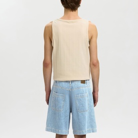 Model wearing Selected light blue denim shorts, styled with a cream sleeveless top. Rear view showing back pockets and relaxed fit.