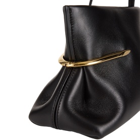 Givenchy Pinch Soft Leather Clutch in black lambskin, close-up showing ruched detail and curved gold-tone pinch hardware