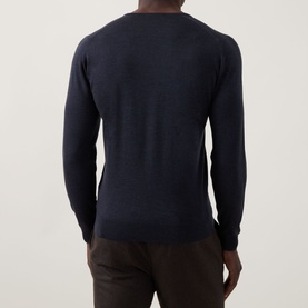 Model wearing John Smedley Blenheim Extra Fine Knit Sweater in Hepburn smoke, rear view, V-neck, long sleeves, ribbed trims, styled with dark trousers