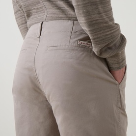 Model wearing Calvin Klein Jeans 90S Straight-Leg Chinos in Vintage Khaki, showing rear jetted pocket with logo badge detail.