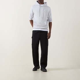 Model wearing Calvin Klein Jeans Twill Cargo Trousers in black, straight-leg fit with cargo pockets, styled with a grey hoodie and black trainers.