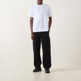 Model wearing Calvin Klein Jeans Monogram Logo T-Shirt in Bright White with black cargo trousers and black trainers