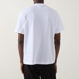Model wearing Calvin Klein Jeans Monogram Logo T-Shirt in Bright White, rear view, short sleeves, straight hem, paired with black trousers.