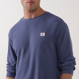 Model wearing Calvin Klein Jeans Waffle Knit Logo T-Shirt in Blue Nomad, crew neck, long sleeves, chest logo badge