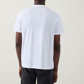 Model wearing Calvin Klein Jeans Travel Line Logo T-Shirt in Bright White, rear view, crew neck, short sleeves, styled with dark jeans.