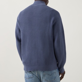 Model wearing Calvin Klein Jeans Waffle-Knit Logo Half-Zip Sweatshirt in Blue Nomad, back view, styled with light-wash jeans