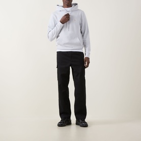Model wearing Calvin Klein Jeans Monogram Badge Drawstring Hoodie in Marble Grey with black cargo trousers and black trainers
