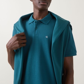 Model wearing Calvin Klein Jeans Tahoe Green Regular Polo with small embroidered logo on chest, short sleeves, classic collar