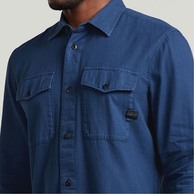 Model wearing G-Star Slim Shirt in Rank Blue GD, featuring twin chest pockets with flap buttons and branded label tab