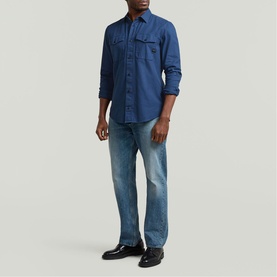 Model wearing G-Star Slim Shirt in Rank Blue GD, styled with light-wash jeans and black leather shoes
