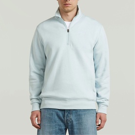 Model wearing G-Star baby blue quarter-zip sweatshirt, styled with light wash jeans