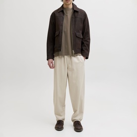 Model wearing Jack & Jones Morel Crew Neck T-shirt, styled with dark brown jacket and cream wide-leg trousers.