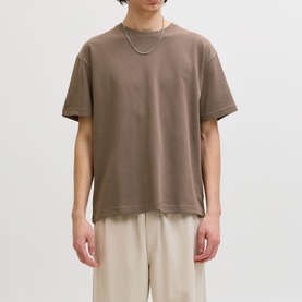 Model wearing Jack & Jones Morel Crew Neck T-shirt, styled with ecru trousers and a silver chain necklace.