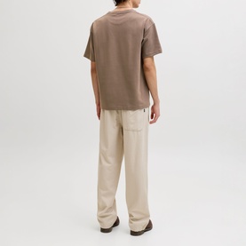 Model wearing Jack & Jones Morel Crew Neck T-shirt, styled with beige wide-leg trousers. Rear view.