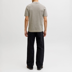 Model wearing Jack & Jones Riley Knit Polo Shirt in brown, short sleeves, quarter-button neck. Styled with black wide-leg trousers. Back view