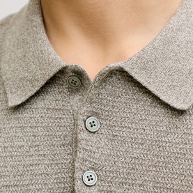 Model wearing Jack & Jones Riley Knit Polo Shirt in brown, close-up of quarter-button fastening and textured knit collar detail