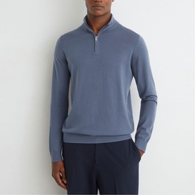 Model wearing Reiss airforce blue half-zip knit jumper, styled with navy trousers