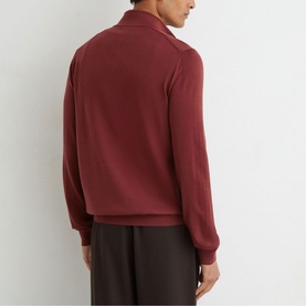 Model wearing Reiss rooibos red zip-up sweatshirt, back view, styled with dark brown trousers.