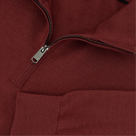 Reiss knitwear in Rooibos Red with half-zip fastening, silver-tone zip and ribbed hem detail, close-up view.