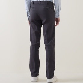 Model wearing Meyer grey cotton-elastane trousers, rear view, styled with a light blue shirt and white trainers.