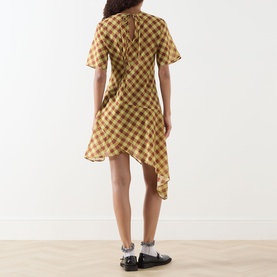 Model wearing Damson Madder Harmony Gingham Mini Dress in multi yellow check, showing asymmetric hemline and keyhole back tie detail. Styled with