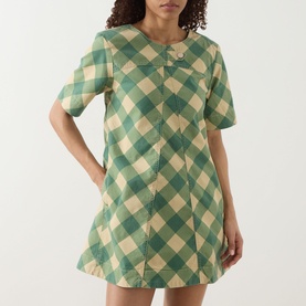 Model wearing Damson Madder Bridget Reversible Mini Dress in green gingham check, short sleeves, A-line silhouette with buttoned tab detail