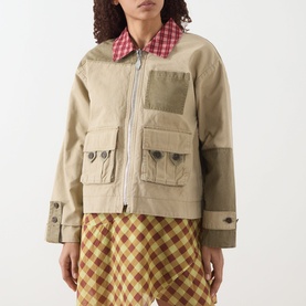 Model wearing Damson Madder Marcelle Reversible Barn Jacket in multi, showing khaki side with red gingham collar, zip front and patch pockets, styled