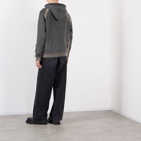 Model wearing Pellador Rib Knit Hoodie in grey, back view, styled with black wide-leg trousers and black shoes.