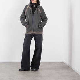 Model wearing Pellador Rib Knit Hoodie in grey with zip fastening and side pockets, styled with wide-leg black jeans and black shoes.