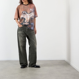 Model wearing Pellador Swan Graphic T-Shirt in print, styled with dark washed wide-leg jeans and black loafers